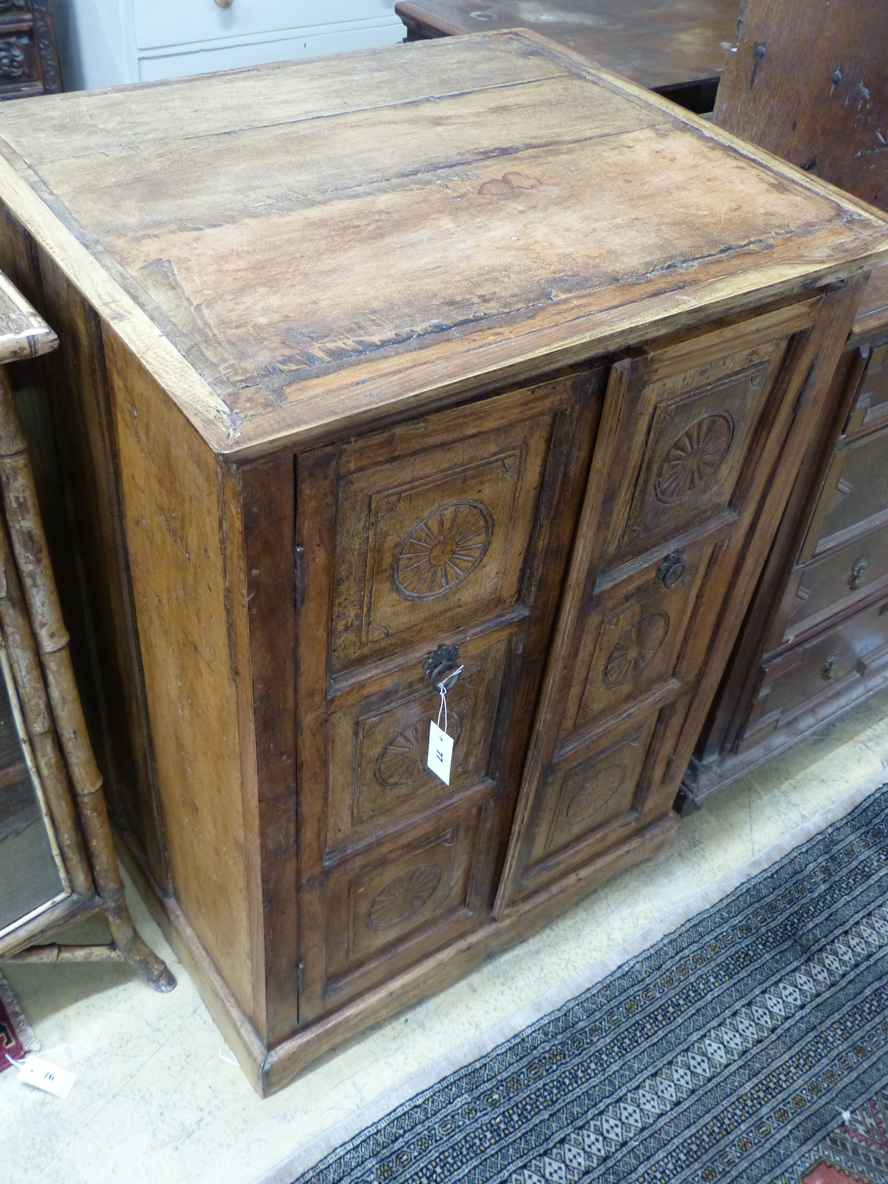 An Indian hardwood carved two door cabinet, width 77cm